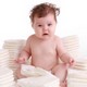 Baby surrounded by diaper stacks