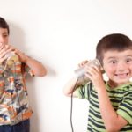 Kids talking on a tin can phone