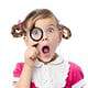 Girl Looking Through a Magnifying Glass