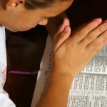 young-girl-praying-open-bible