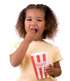 little girl eating popcorn