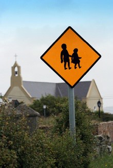 Children crossing sign with church in the background