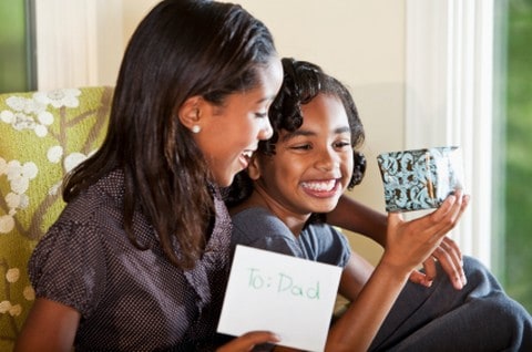 Girls with present & a card for their Dad