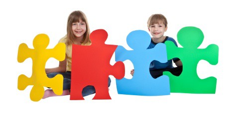 Kids holding large puzzle pieces