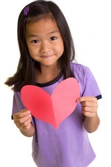 Girl holding paper heart