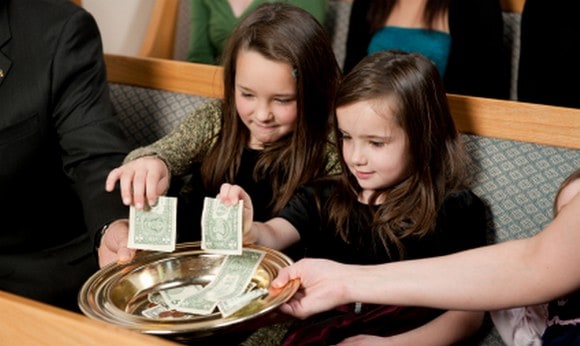 Church offering with two girls
