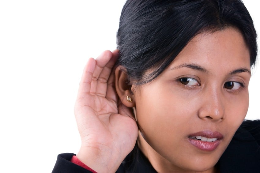 A woman trying to listen the sound around her