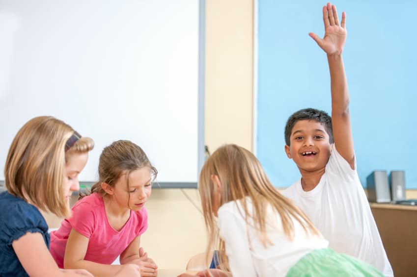 boy-raising-hand-in-classroom